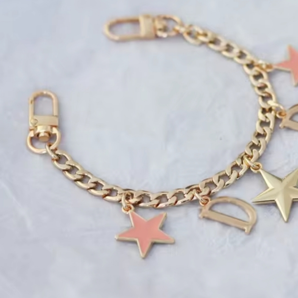 Unbranded Gold Bag Charm/Strap extender Star&D design with lobster clasp.